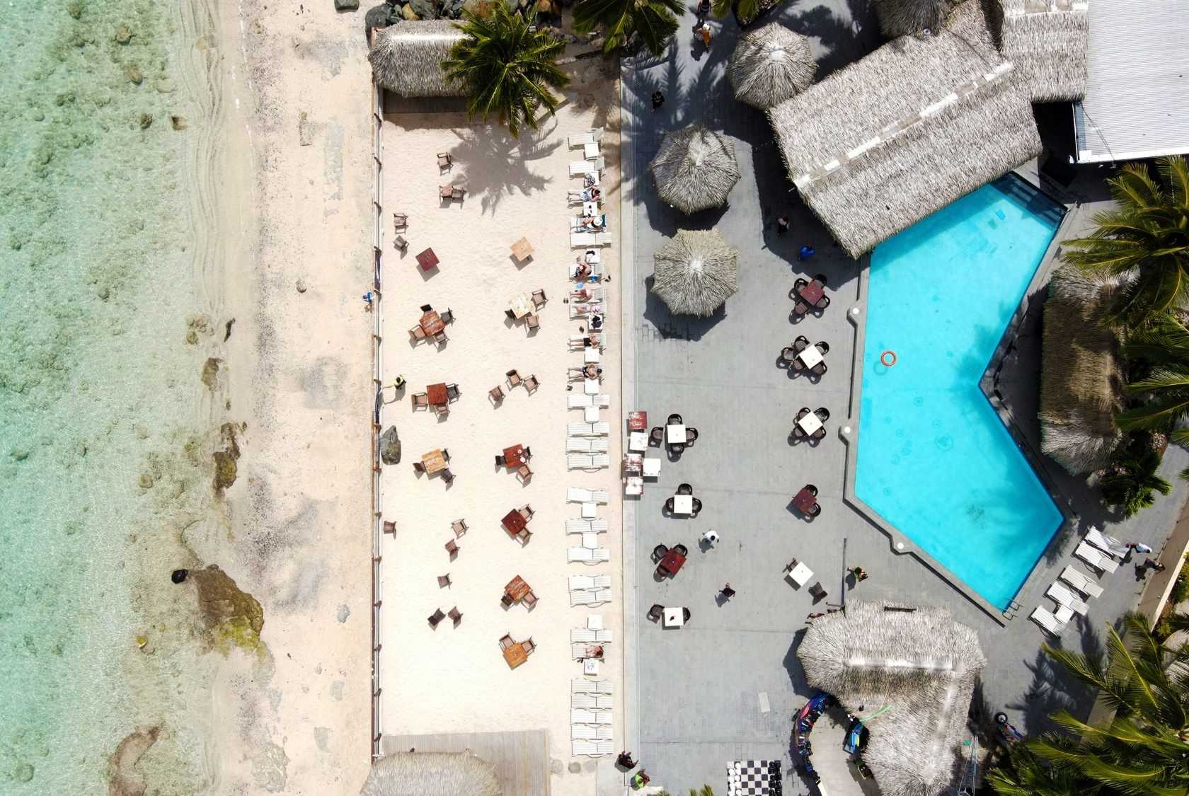 Stunning aerial view of Edgewater Resort’s beachfront dining and poolside relaxation area in Rarotonga, Cook Islands.