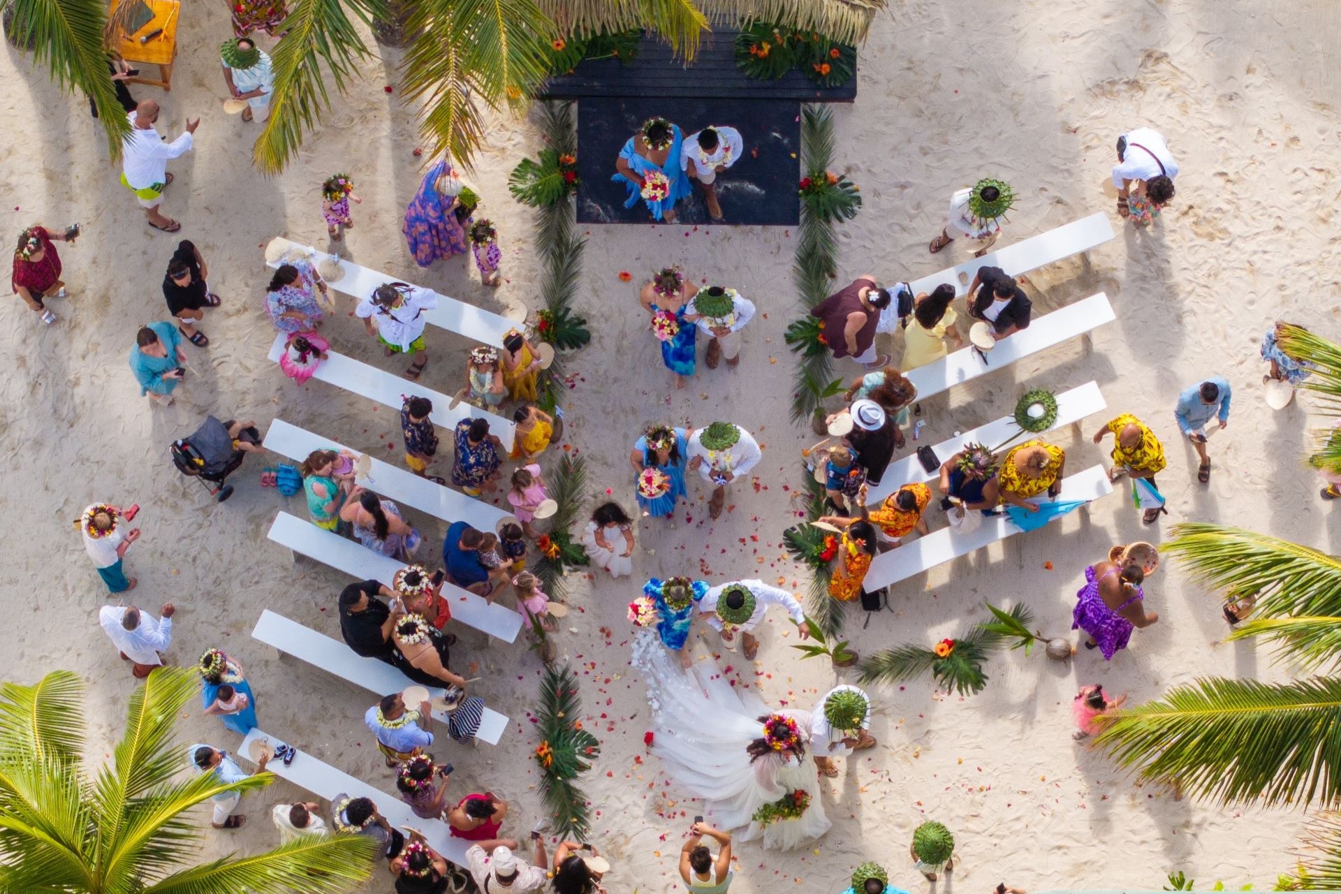 A stunning aerial view of a beautiful beachfront wedding ceremony at Edgewater Resort in the Cook Islands.